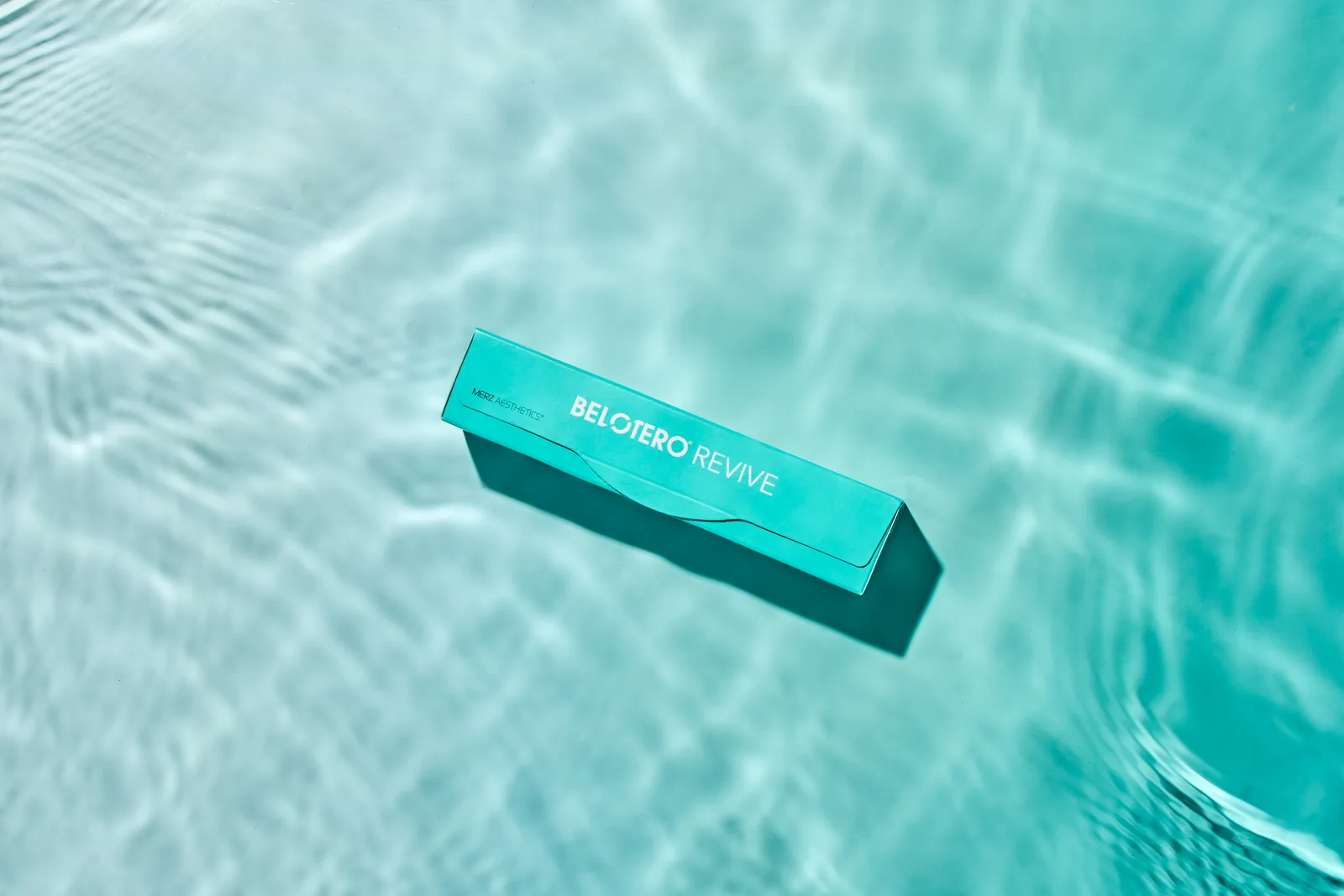 Belotero Revive carton floating on rippling turquoise water
