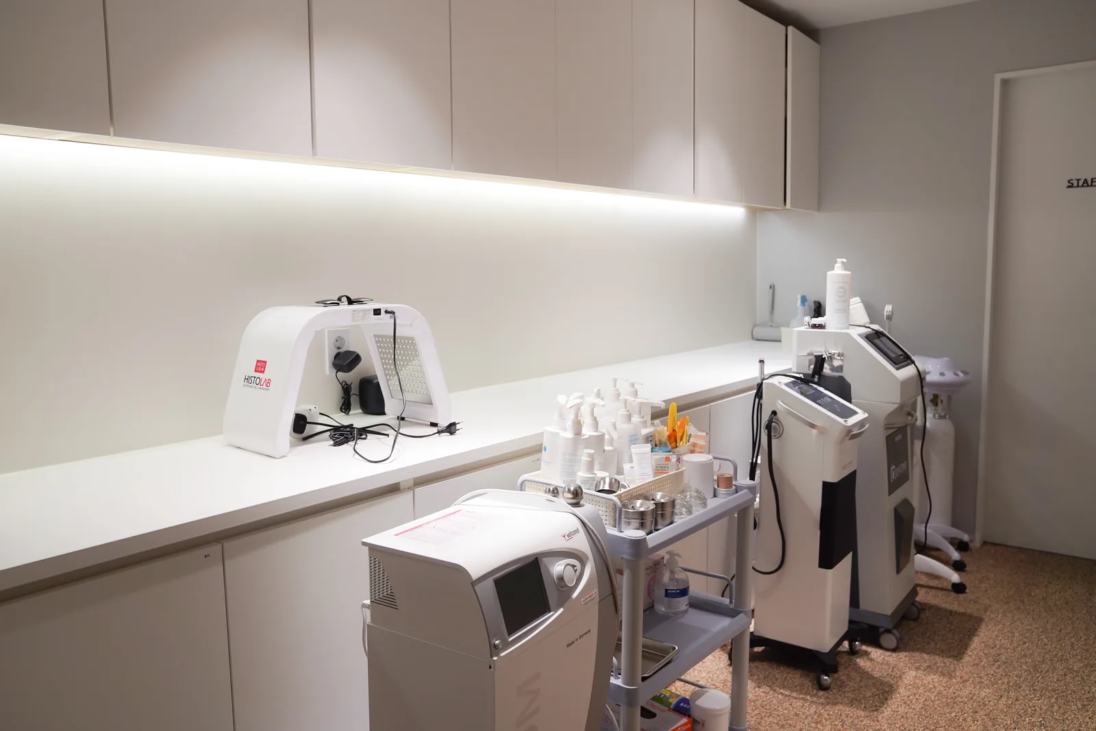 Aesthetic care room with an LED panel and hydro-peel unit at Dear Clinic Cheongdam