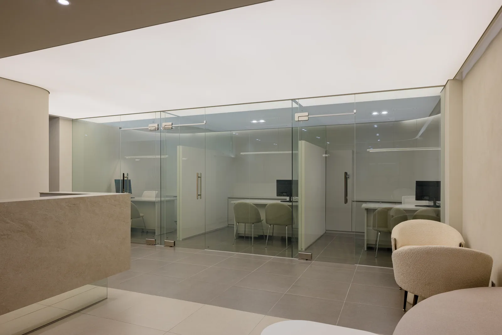 Glass-walled consultation rooms at Dear Clinic where the doctor reviews the treatment plan before any procedure