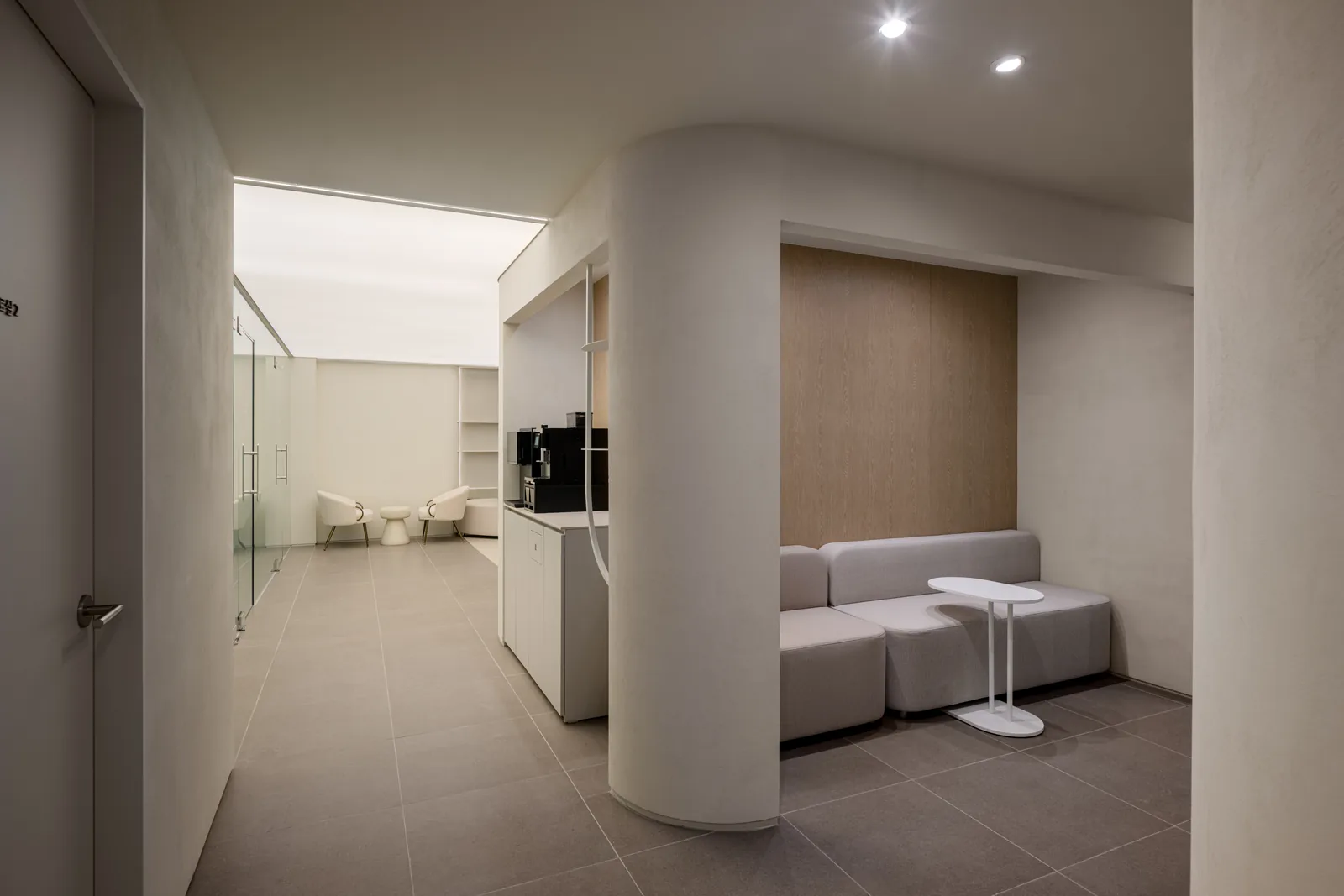 Waiting nook and coffee bar along the treatment corridor at Dear Clinic Cheongdam