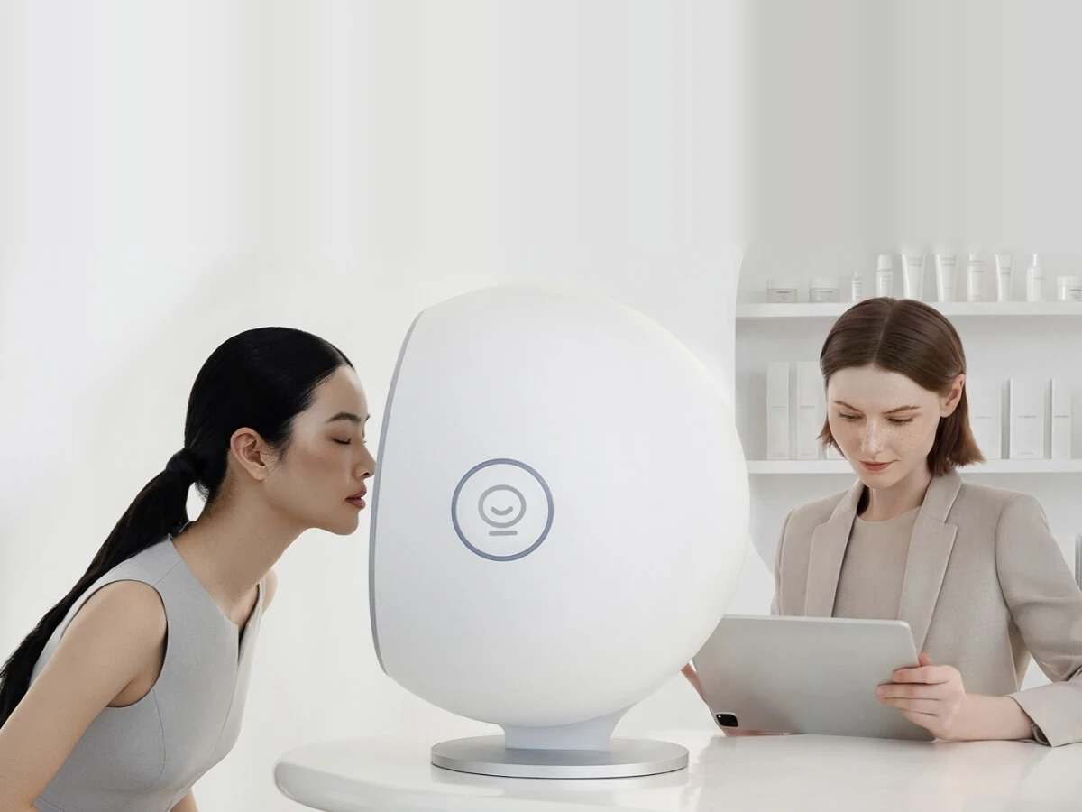 A client leans into the EVE 3D skin analysis unit while the scan is reviewed on a tablet